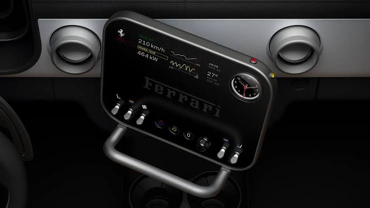 Ferrari Luce digital dashboard display flanked by physical knobs, switches, and dials